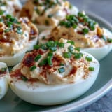 These creamy Million Dollar Deviled Eggs feature a tangy filling made with Dijon mustard and cream cheese.