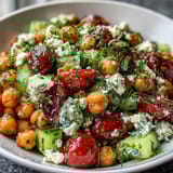 Cold chickpea salad with lemon herbs, a vibrant Mediterranean dish with juicy tomatoes and crisp cucumbers.  