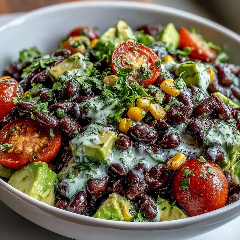 Hearty Black Bean and Veggie Bowl featuring juicy tomatoes, sweet corn, and pumpkin seeds over a colorful mix.